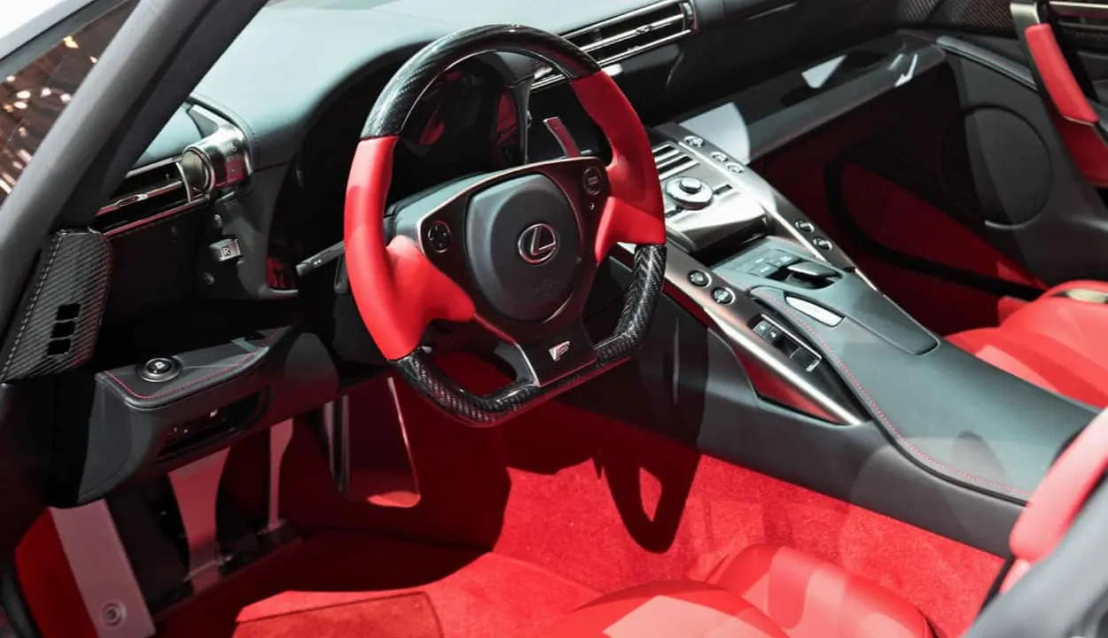 The red and black interior of a Lexus sports car