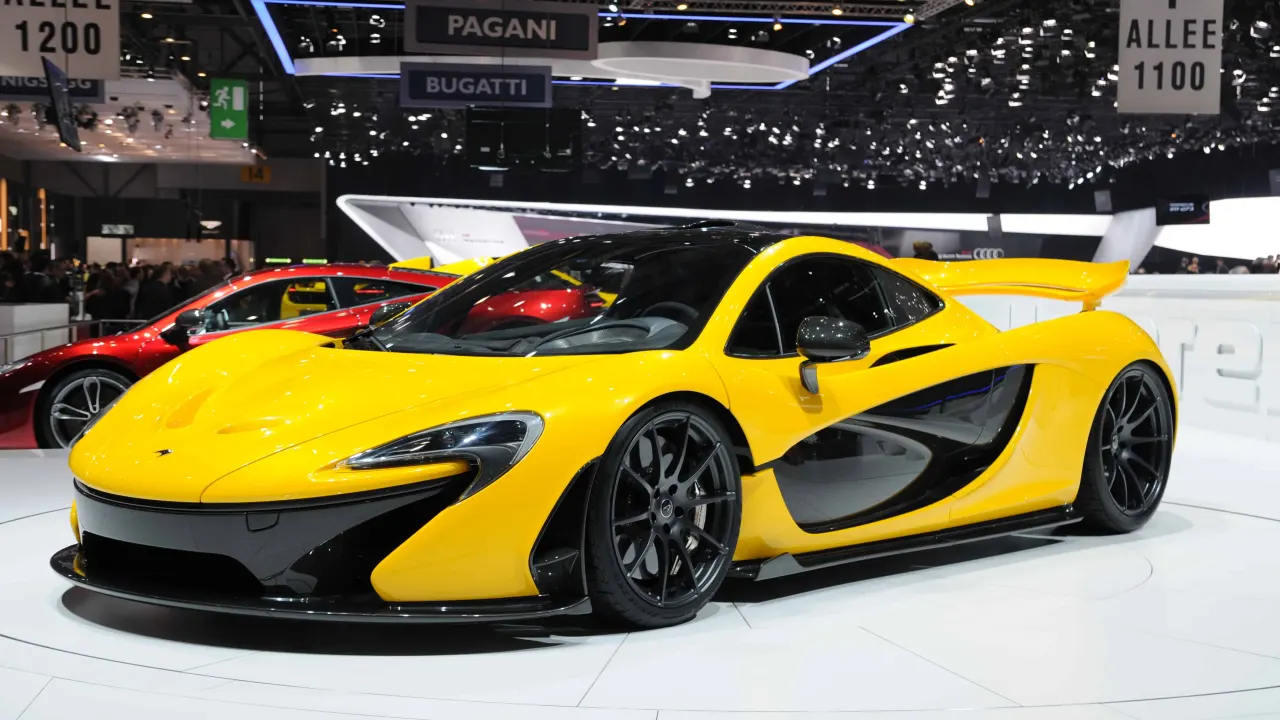 A yellow McLaren P1 on a motor show stand