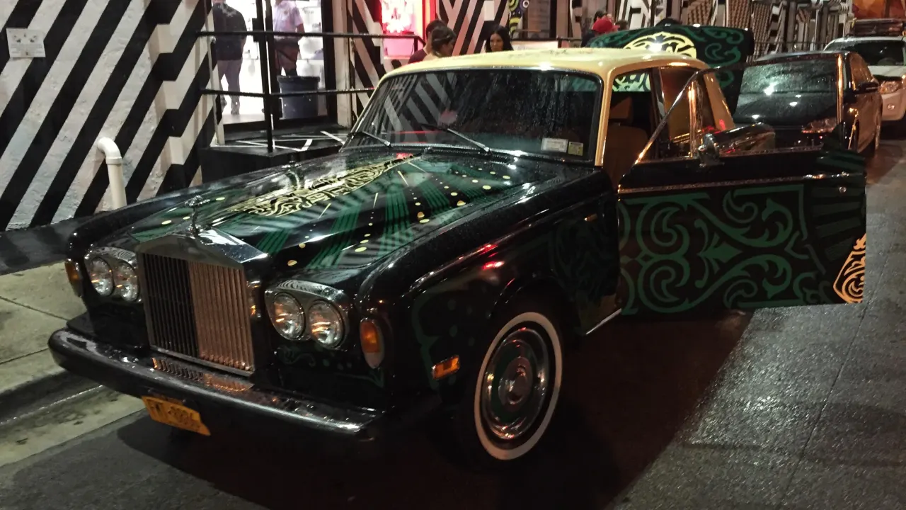 A Rolls-Royce painted with ornate green artwork