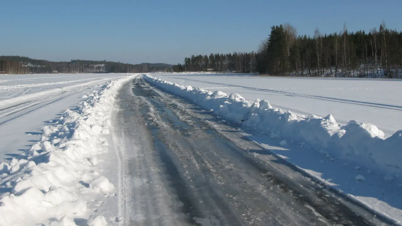 A plowed ice road running between snowbanks