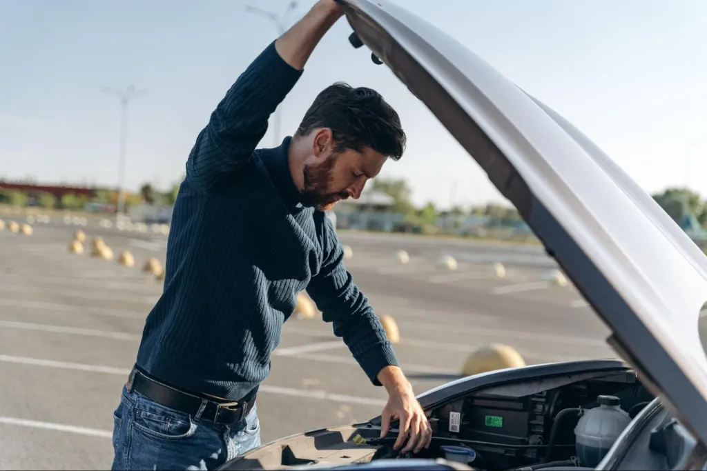 man fixing error code p0174 in parking lot