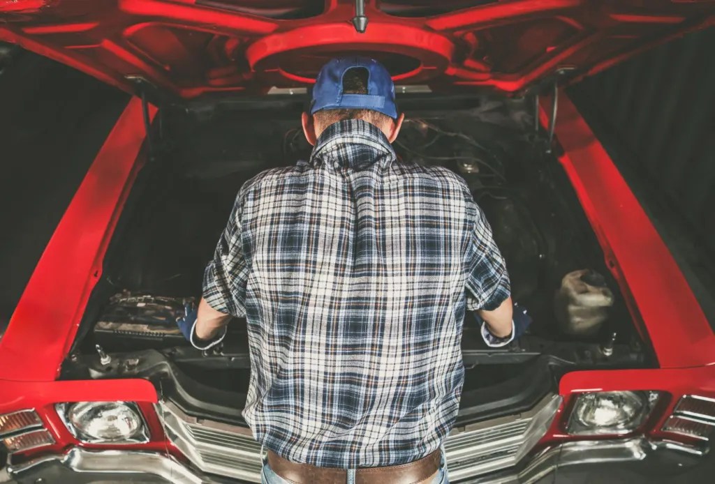 Man doing DIY car computer repair before buying a new ECM