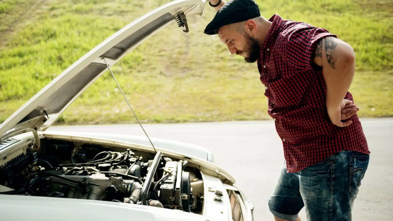 Auto mechanic using tools under the hood to diagnose a vehicle where the OBD has power but no communication.