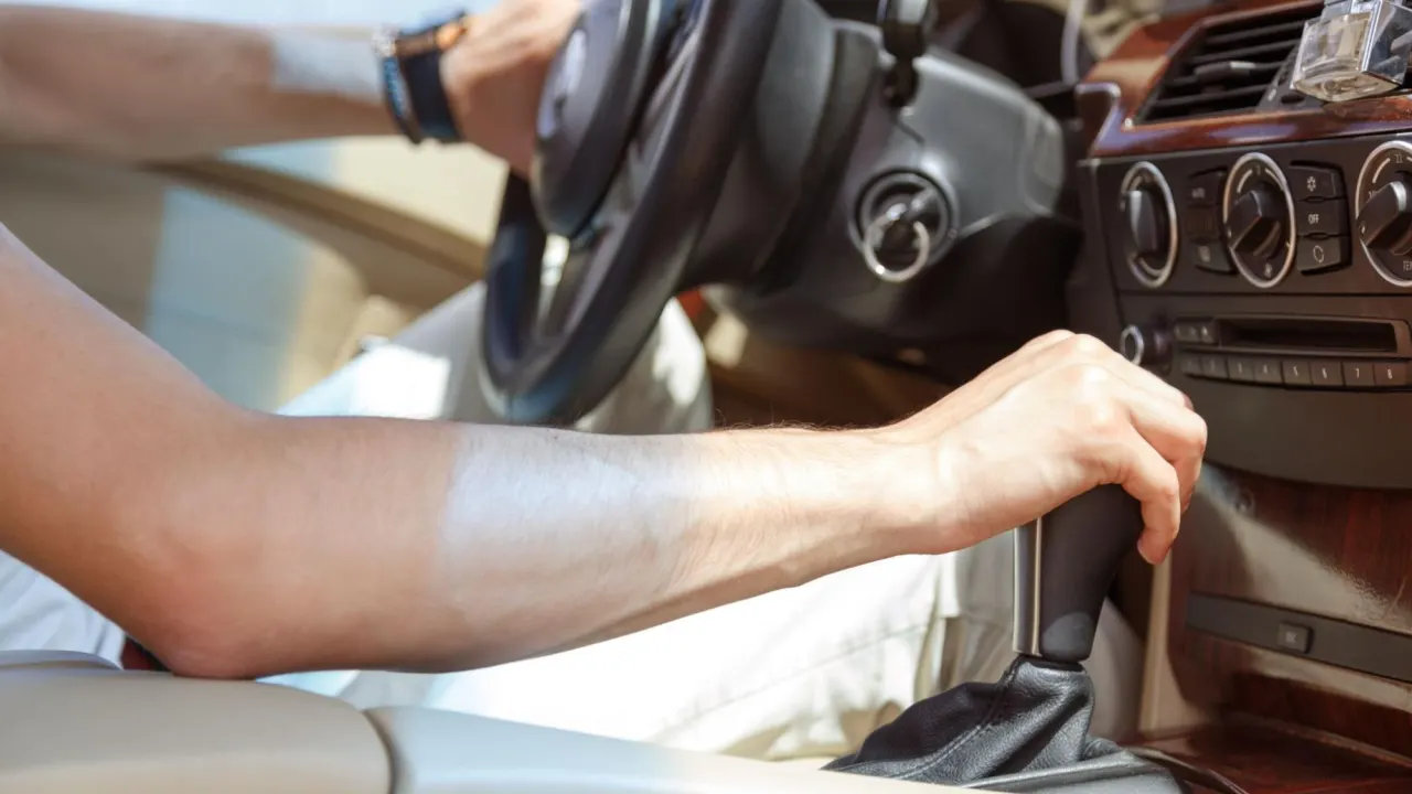 Person inside a car interacting with dashboard controls, searching for ecm testing near me