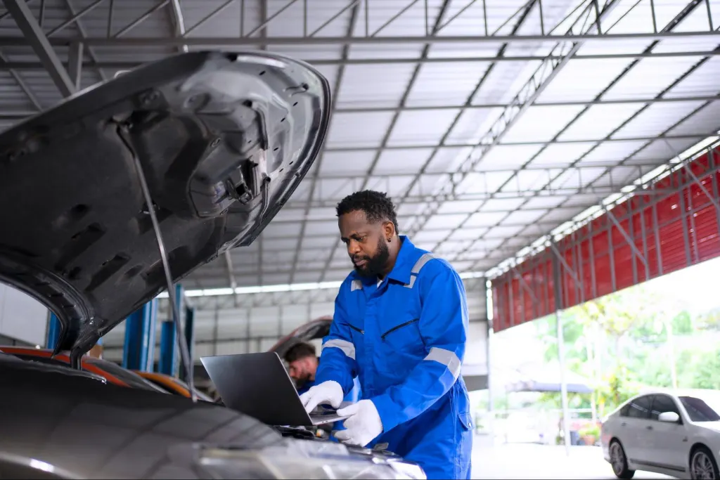 Where Can I Get My PCM Reprogrammed? Engine Bay Scan Tools Technician inspecting engine bay components with scan tools before PCM reprogramming, where can i get my pcm reprogrammed